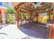 Enjoy outdoor living in a tiki bar setting, with seating and a view of lush landscaping and a sparkling pool at 1440 Rawhide Rd, Boulder City, NV 89005