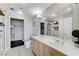 This sleek bathroom features a double vanity, tiled floors, and a glass-enclosed shower for modern convenience at 150 Las Vegas Blvd # 1118, Las Vegas, NV 89101