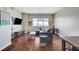 Inviting living room featuring hardwood floors, comfortable seating, and a large window with city views at 150 Las Vegas Blvd # 1118, Las Vegas, NV 89101