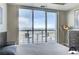 Bright bedroom with city views from the balcony, hardwood floors, and a contemporary dresser at 150 Las Vegas Blvd # 1118, Las Vegas, NV 89101