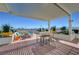 Stylish rooftop deck features a mix of seating options, colorful planters, modern sunshade, and panoramic city views at 150 Las Vegas Blvd # 1118, Las Vegas, NV 89101