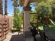 Enjoy outdoor living in this backyard with a dining area, green lawn, playset, and mature trees for shade at 1800 Quail Point Ct, Las Vegas, NV 89117