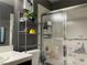Bathroom with a shower, decorative accents, and storage shelves, offering both functionality and charm at 1800 Quail Point Ct, Las Vegas, NV 89117