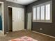 Bedroom featuring neutral tones, window with wooden shutters, a built-in closet and full-length mirror at 1800 Quail Point Ct, Las Vegas, NV 89117