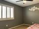This bedroom has a neutral palette, a ceiling fan and a window with wooden shutters, creating a relaxing space at 1800 Quail Point Ct, Las Vegas, NV 89117