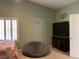Comfortable bedroom featuring a cozy beanbag chair, TV, and natural light from a window at 1800 Quail Point Ct, Las Vegas, NV 89117