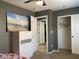 Cozy bedroom featuring a dresser with a serene ocean view artwork and a closet for ample storage at 1800 Quail Point Ct, Las Vegas, NV 89117