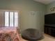 Inviting bedroom with a comfortable beanbag chair, TV, and window with shutters at 1800 Quail Point Ct, Las Vegas, NV 89117