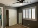 Bedroom featuring neutral tones, window with wooden shutters, a built-in closet and full-length mirror at 1800 Quail Point Ct, Las Vegas, NV 89117