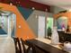 Dining space with colorful accent walls, a wooden dining table, and an open concept design at 1800 Quail Point Ct, Las Vegas, NV 89117