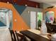 Dining space with colorful accent walls, a wooden dining table, and an open concept design at 1800 Quail Point Ct, Las Vegas, NV 89117