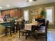 Cozy dining area featuring a wooden table, comfortable seating, and natural light from shuttered windows at 1800 Quail Point Ct, Las Vegas, NV 89117