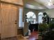 Inviting home entry with arched windows and a decorative front door with sidelights and plants at 1800 Quail Point Ct, Las Vegas, NV 89117