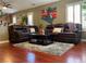 Comfortable living room featuring hardwood floors, plush area rug, and two leather sofas at 1800 Quail Point Ct, Las Vegas, NV 89117