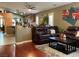 Spacious living room featuring hardwood floors, a plush rug, and comfortable leather seating at 1800 Quail Point Ct, Las Vegas, NV 89117