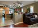 Open living area with modern archway, wood floors, leather sofa, and views into kitchen at 1800 Quail Point Ct, Las Vegas, NV 89117