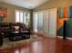 Living room with wood floors, comfortable seating, and large windows with plantation shutters at 1800 Quail Point Ct, Las Vegas, NV 89117