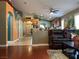 Open-concept space with hardwood floors, archways, comfortable leather furniture, and plants at 1800 Quail Point Ct, Las Vegas, NV 89117