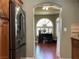 View from kitchen to office space with hardwood floors and natural light from an arched window at 1800 Quail Point Ct, Las Vegas, NV 89117