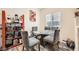 Cozy dining area with a round glass table and comfortable chairs, illuminated by natural light from a nearby window at 2110 Los Feliz St # 1066, Las Vegas, NV 89156