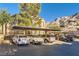 Exterior view of the building with covered parking, lush landscaping, and mountain views at 2110 Los Feliz St # 1066, Las Vegas, NV 89156