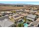 The aerial view showcases a backyard pool, desert landscaping, and the surrounding community at 2400 Trissino Ct, Henderson, NV 89044