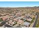 This aerial view displays homes in the community along with desert landscape, roads, and mountains at 2400 Trissino Ct, Henderson, NV 89044