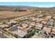 Expansive aerial view showcases a residential area with pools, solar panels and beautiful desert landscape at 2400 Trissino Ct, Henderson, NV 89044