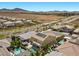 This aerial view highlights the home and pool, with a view of the desert and mountains at 2400 Trissino Ct, Henderson, NV 89044