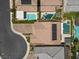 An aerial view showcases a well-maintained property with a tile roof and solar panels at 2400 Trissino Ct, Henderson, NV 89044