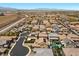 Aerial view featuring houses, community streets, landscaping, and the surrounding desert landscape at 2400 Trissino Ct, Henderson, NV 89044