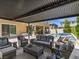 Inviting backyard patio featuring comfortable outdoor furniture and a refreshing pool with a lounge area at 2400 Trissino Ct, Henderson, NV 89044