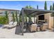 Stylish outdoor space with a patio, outdoor fireplace, lounge area, and a pool, perfect for relaxation at 2400 Trissino Ct, Henderson, NV 89044