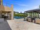 Expansive backyard featuring a pool, patio area, and covered outdoor seating, ideal for outdoor entertaining at 2400 Trissino Ct, Henderson, NV 89044