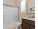 Well-lit bathroom with a frosted glass shower, white marble sink top, and warm neutral colors at 2400 Trissino Ct, Henderson, NV 89044
