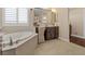 Bathroom features a makeup vanity and separate tub at 2400 Trissino Ct, Henderson, NV 89044