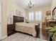 Charming bedroom featuring a queen bed, plantation shutters and a chandelier, creating a relaxing atmosphere at 2400 Trissino Ct, Henderson, NV 89044
