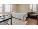 Bright bedroom with a work area, piano, large windows with shutters, and light hardwood flooring at 2400 Trissino Ct, Henderson, NV 89044