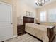 Cozy bedroom featuring a dark wood bedroom set, plantation shutters, and a decorative chandelier at 2400 Trissino Ct, Henderson, NV 89044