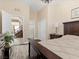 Comfortable bedroom showcasing dark wood floors and furniture, with a view to the home's staircase at 2400 Trissino Ct, Henderson, NV 89044