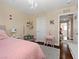 Light and airy bedroom with a fluffy pink bed, vanity, and chandelier for a whimsical touch at 2400 Trissino Ct, Henderson, NV 89044
