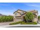 Attractive two-story home includes a three-car garage, stone details, and well-maintained landscaping at 2400 Trissino Ct, Henderson, NV 89044