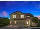 Stunning two-story home showcases a three-car garage, stone accents, and manicured landscaping under a twilight sky at 2400 Trissino Ct, Henderson, NV 89044