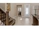 Bright entryway showcases a staircase, decorative lighting, and tasteful decor, leading into the home's living areas at 2400 Trissino Ct, Henderson, NV 89044