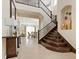 Elegant foyer with grand staircase, high ceilings, and stylish decor creates an inviting first impression at 2400 Trissino Ct, Henderson, NV 89044