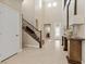 Spacious foyer features a staircase, high ceilings, stylish lighting, and neutral tones for a welcoming ambiance at 2400 Trissino Ct, Henderson, NV 89044