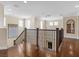 Spacious hallway with hardwood floors, a decorative light fixture, and a wooden staircase at 2400 Trissino Ct, Henderson, NV 89044