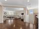 Open floor plan hallway featuring hardwood floors and view into living spaces at 2400 Trissino Ct, Henderson, NV 89044