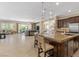 Open concept kitchen with granite counters, a central island and access to the living area at 2400 Trissino Ct, Henderson, NV 89044