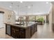 Spacious kitchen with a large island, dark wood cabinets, and stainless steel appliances at 2400 Trissino Ct, Henderson, NV 89044